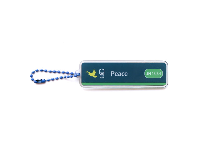 Front view of Train Station Peace Christian acrylic keychain featuring John 13:34 and blue ball chain