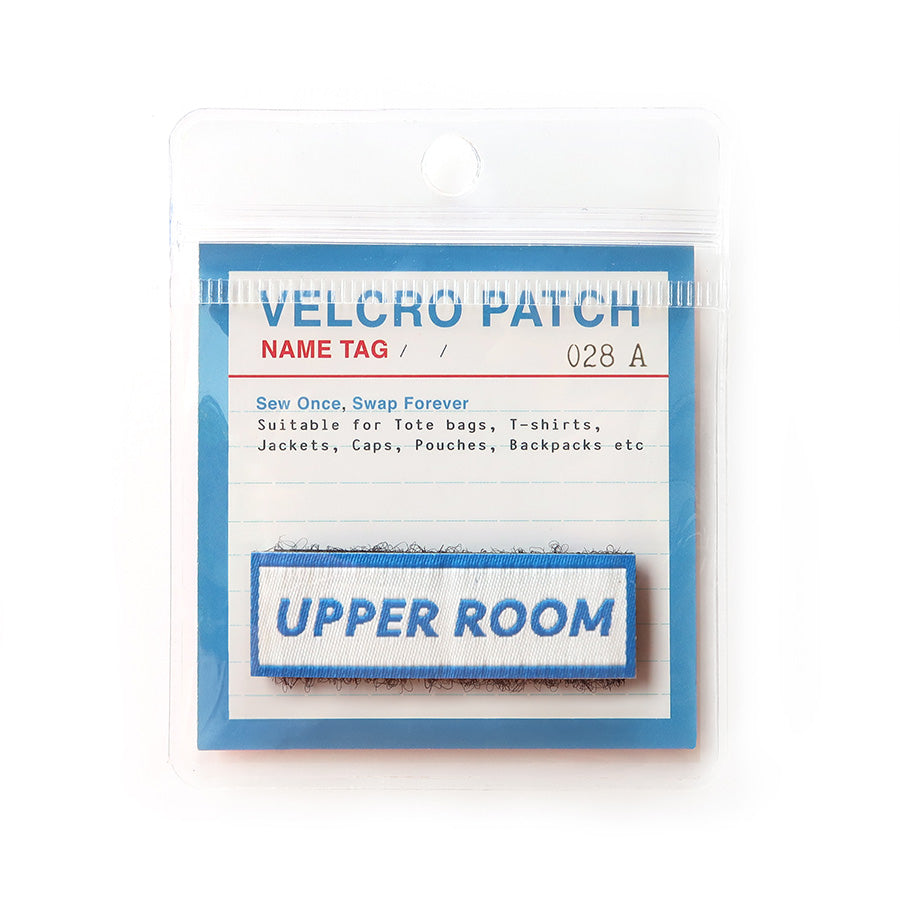 Velcro tag featuring 'Upper Room' text in blue on a white background, a Christian-inspired accessory for apparel and bags.