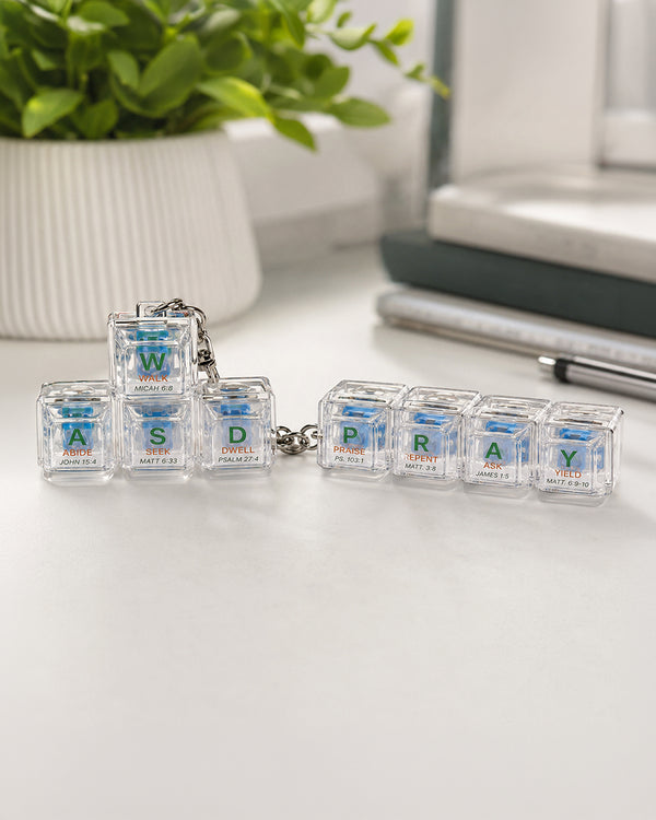 Walk Abide Seek Dwell and PRAY light-up keycap keychains together