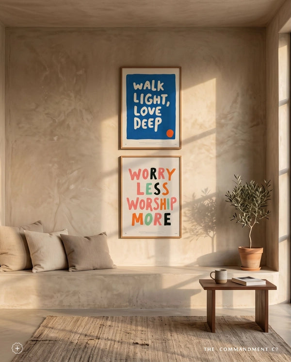 Walk Light Love Deep blue Christian poster displayed above Worry Less Worship More wall art in a warm sunlit living room
