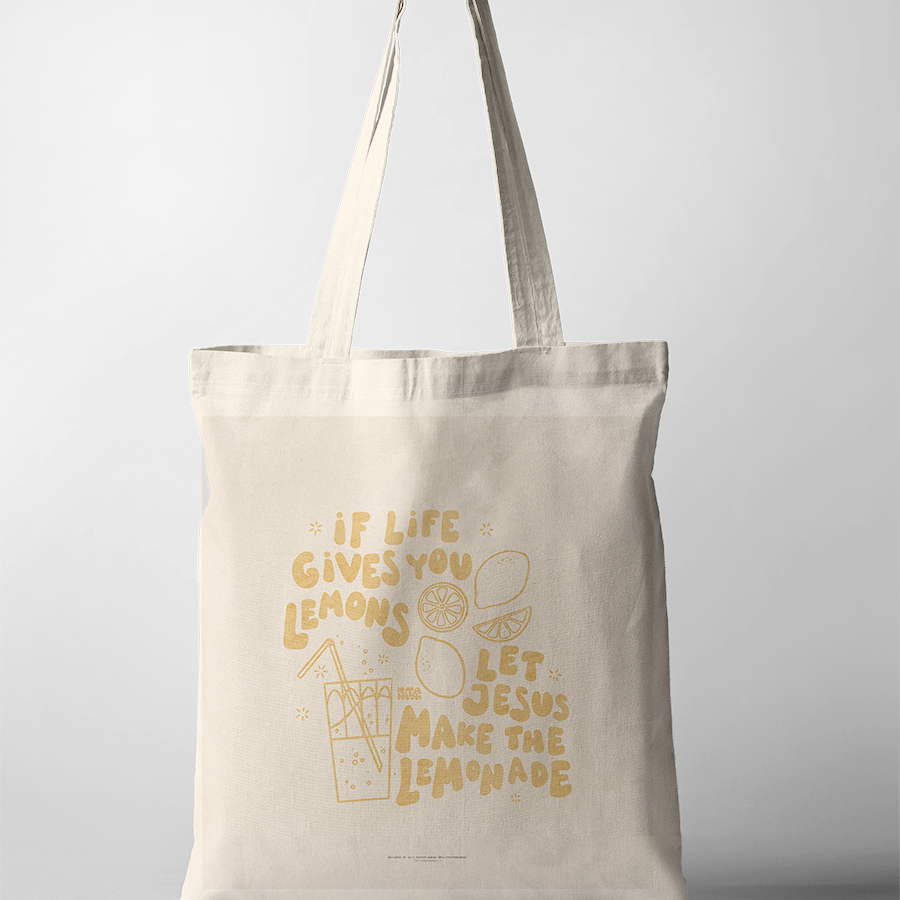 a tote bag, featuring cheerful yellow hand-drawn lemons and a glass of lemonade, reflecting simple happiness and Christian encouragement.