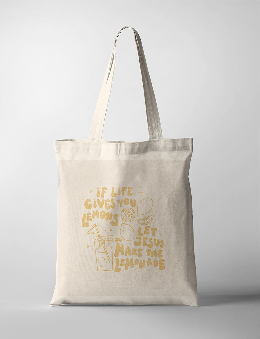 a tote bag, featuring cheerful yellow hand-drawn lemons and a glass of lemonade, reflecting simple happiness and Christian encouragement.