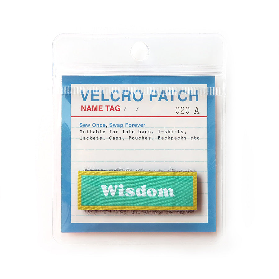 Wisdom Velcro tag with a green and gold design, providing an inspirational message for bags, jackets, and other accessories.