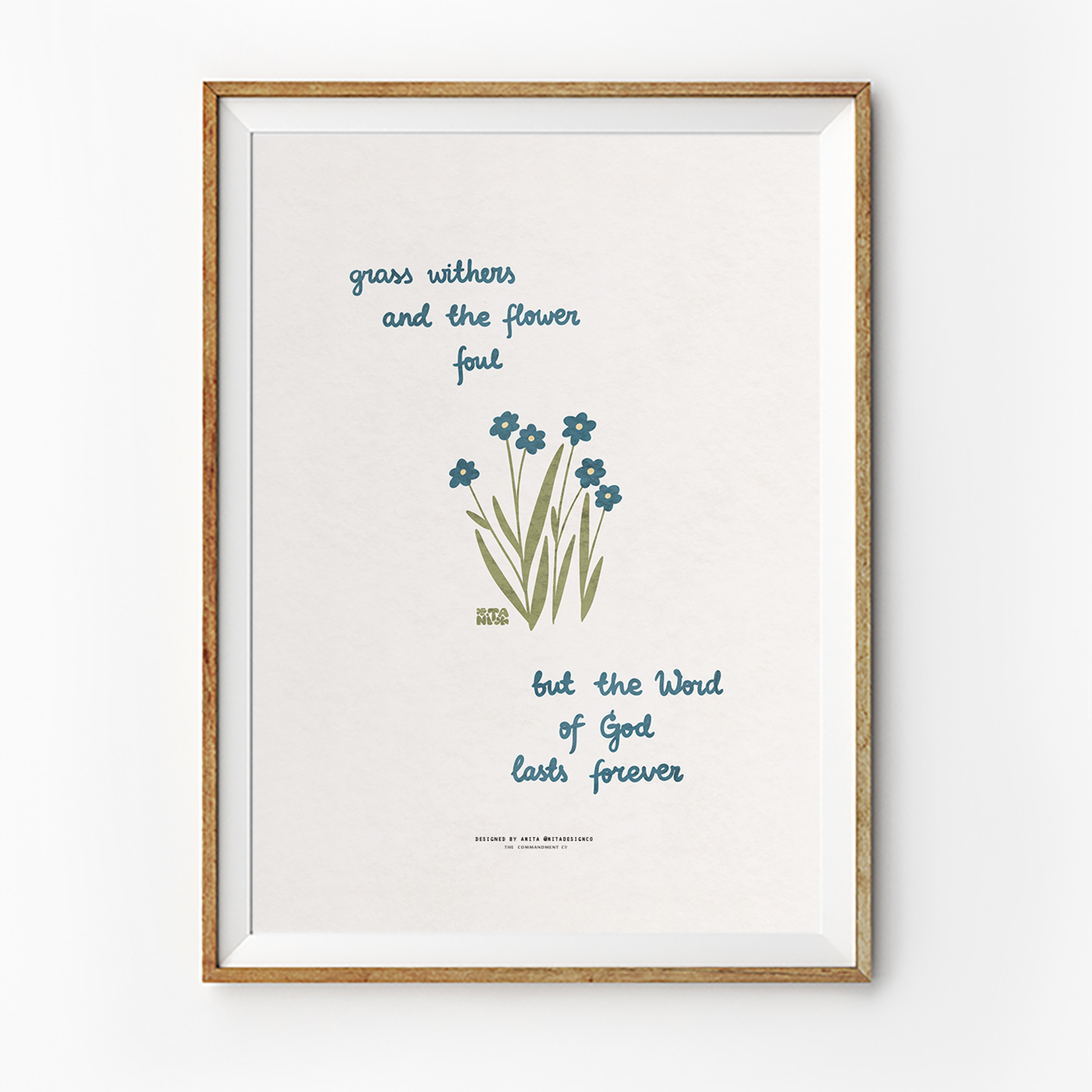 Inspirational Christian poster in a wooden frame with the words "grass withers and the flower fall, but the Word of God lasts forever," featuring simple blue flowers and green grass, reflecting faith and simple happiness.