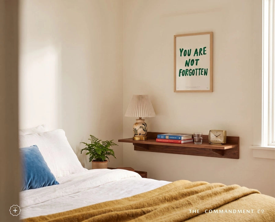 You Are Not Forgotten Christian poster displayed above a wooden shelf in a warm neutral bedroom