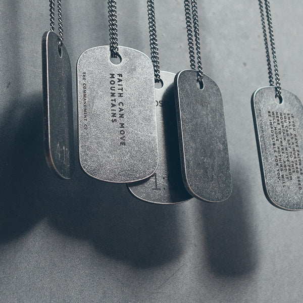Gunmetal dog tag necklace worn as a personalised accessory