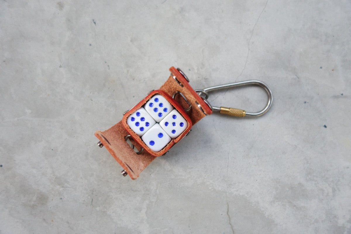 The square case comes with 4 small dice.