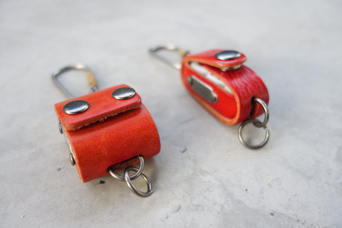 The square dice case comes with 4 dice while the rectangle one holds 3 dice.