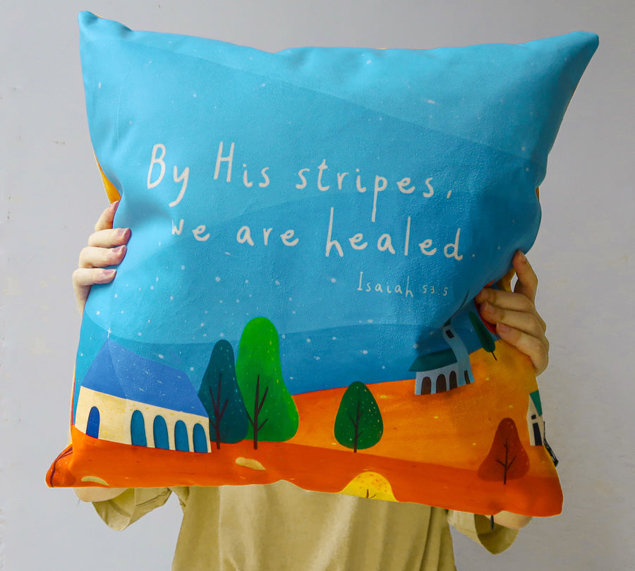 By His Stripes Isaiah 53:5 Christian cushion cover shown in a lifestyle view.