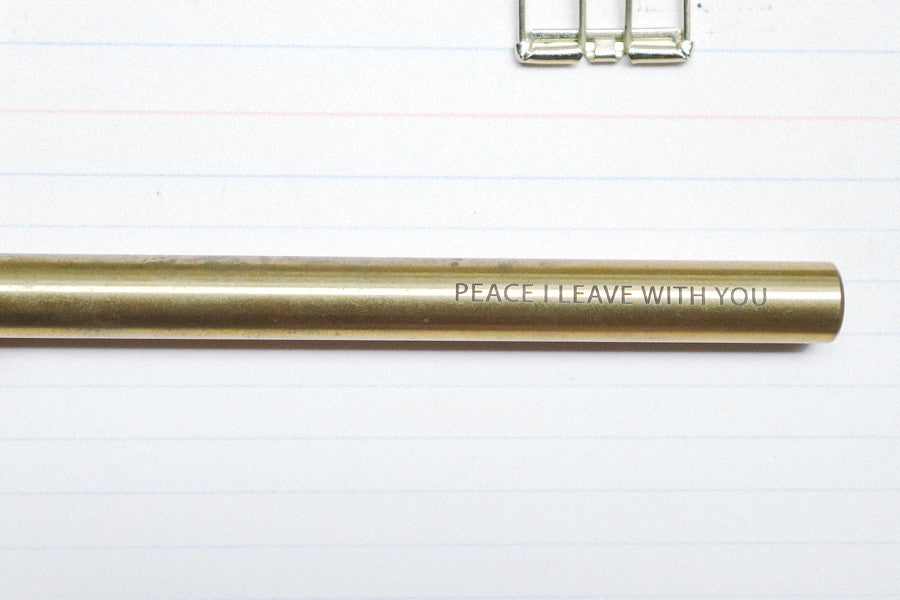 Brass pen barrel with the message 'peace I leave with you'.