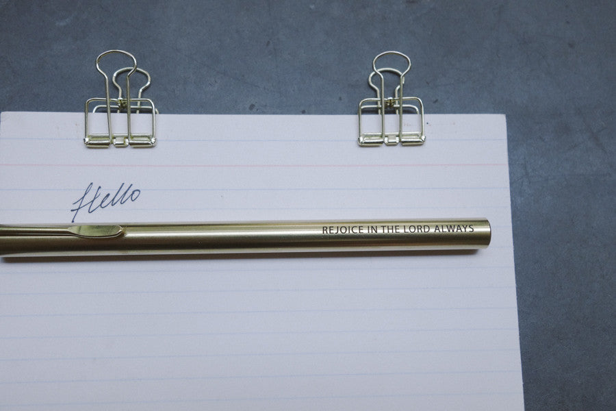 Brass pen barrel with the message 'Rejoice in the Lord always'.