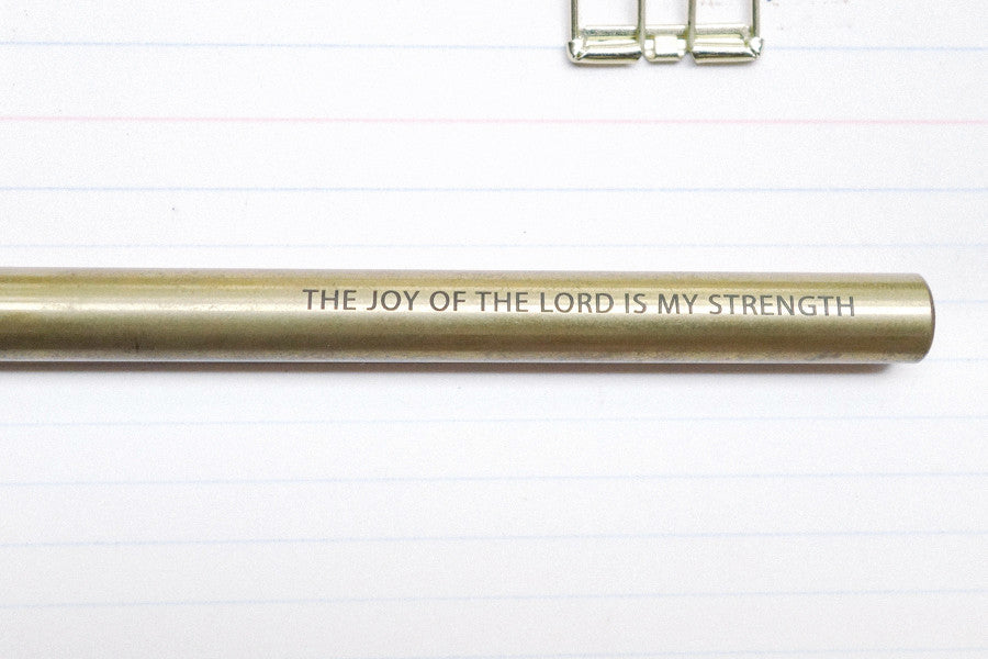 Brass pen barrel with the message 'The joy of the Lord is my strength'.