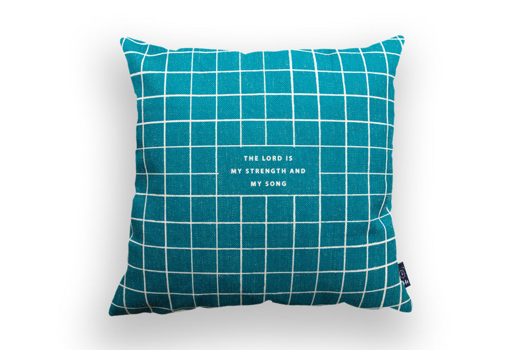 grid designs on the blue pillow with the verse 'the lord is my strength and my song'.