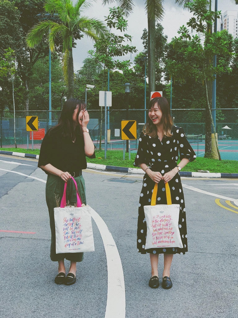 BELIEVING En:Courage canvas tote bag by The Brave Assembly, lifestyle view.