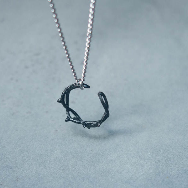 Close-up of Black Gunmetal Crown of Thorns necklace pendant.
