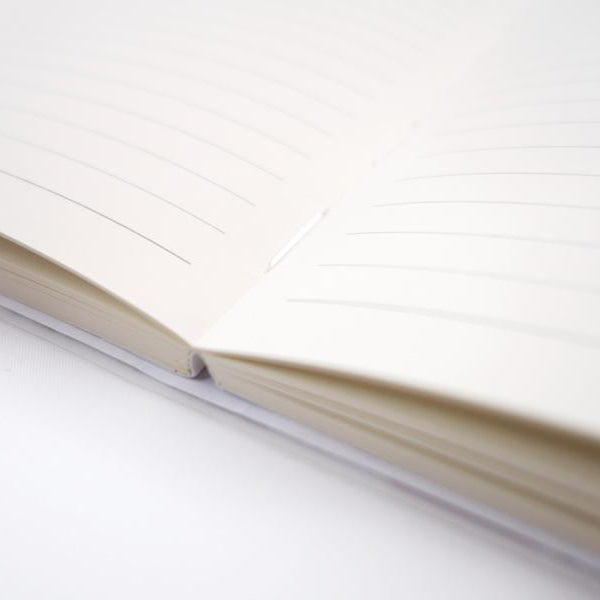 Mercy, Peace and Love A5 lined Christian notebook showing binding and pages.