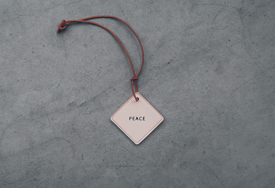 Peace leather car charm by The Messenger by TCCO for a vehicle rear-view mirror.