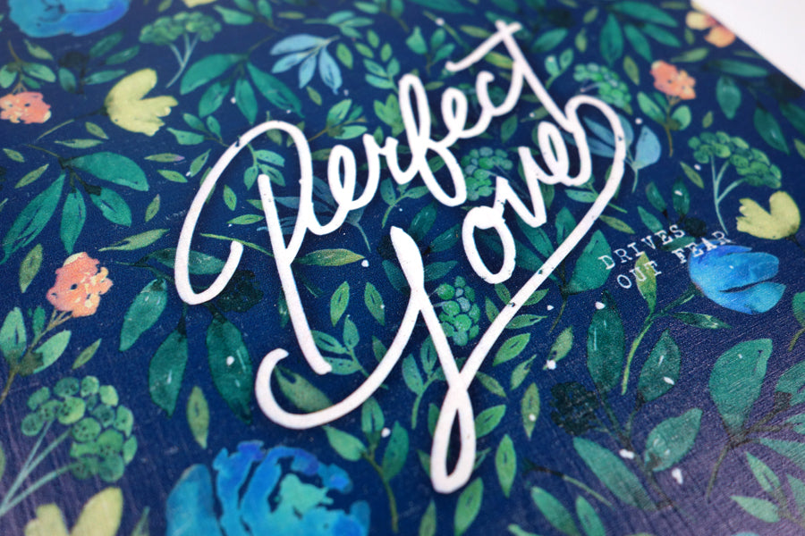 Close up of motivational bible verse ‘Perfect Love’ on floral background digitally printed on 16cmx20cm quality pine wood.