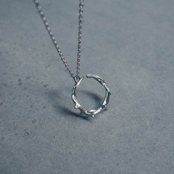 Close-up of Silver Crown of Thorns necklace pendant.