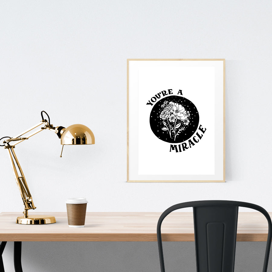 A3 beautiful calligraphy poster placed standing on a wooden table. Modern Christian home interior design ideas.