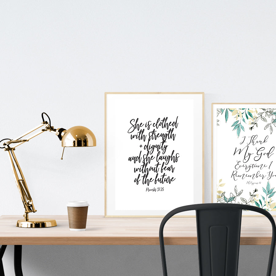 A3 beautiful calligraphy poster placed standing next to a smaller A4 sized calligraphy poster on a wooden table. Rustic home interior design ideas.