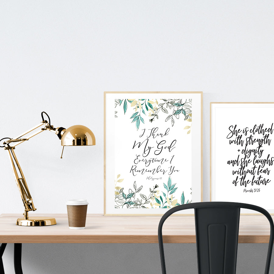 A3 beautiful calligraphy poster placed standing next to a smaller A4 sized calligraphy poster on a wooden table. Modern home interior design ideas.