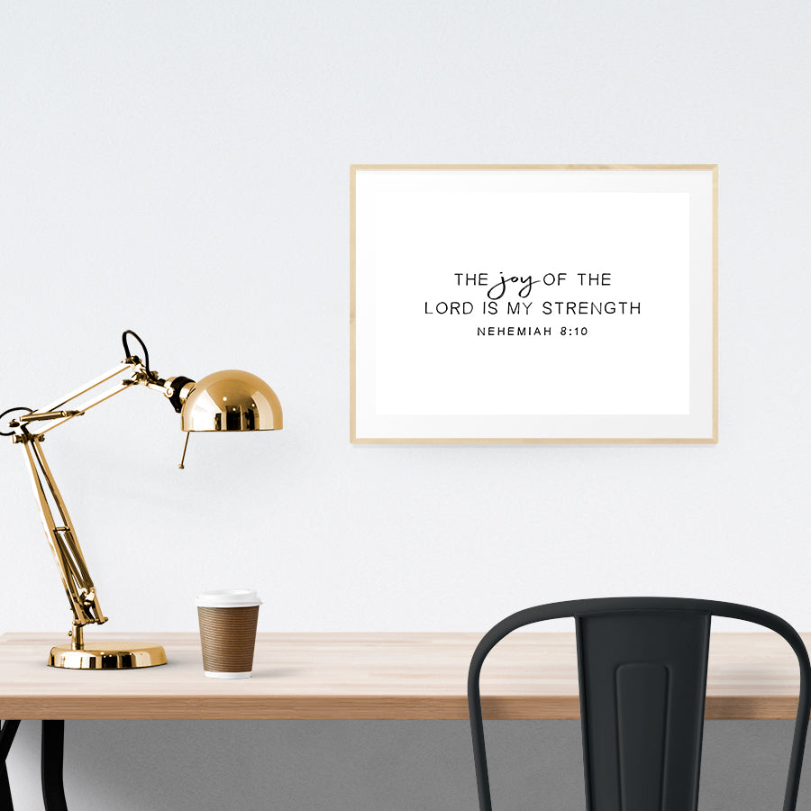 A3 beautiful calligraphy poster placed standing next to a smaller A4 sized calligraphy poster on a wooden table. Modern home interior design ideas.