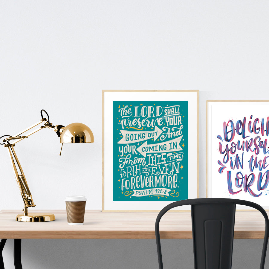 A3 calligraphy poster placed standing next to a smaller A4 sized calligraphy poster with on a wooden table. Inspiring home decor ideas.