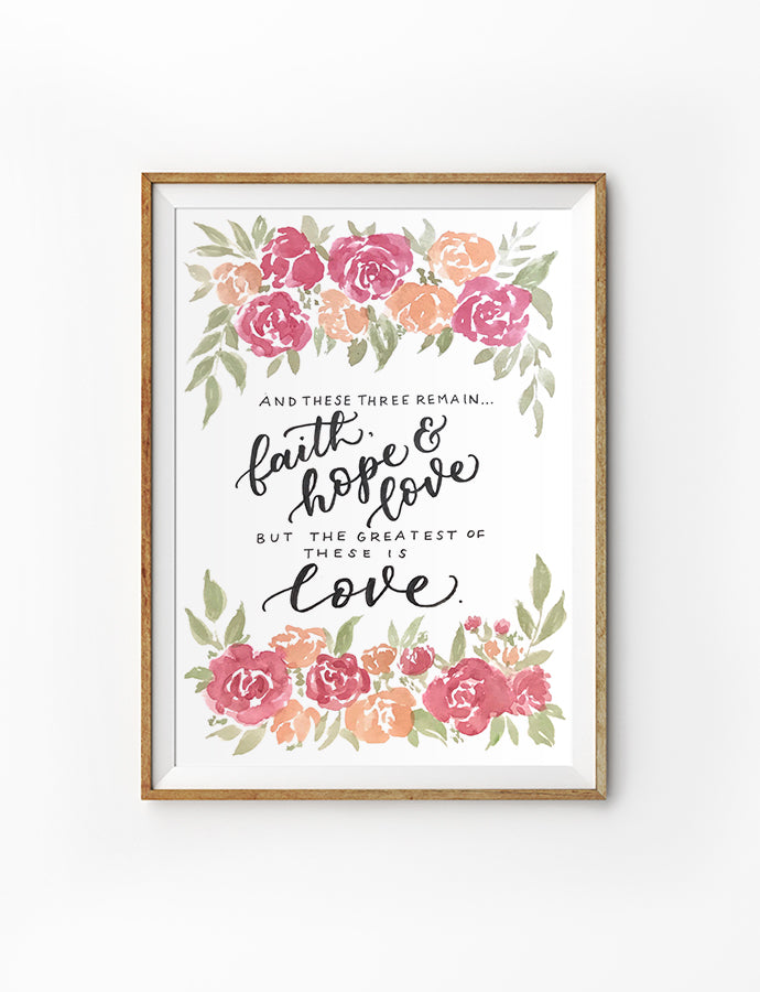 Poster featuring typography bible verses with flowers designs ‘And these three remains-Faith, hope and love, but the greatest of these is love. is hung on the wall in a gold photo frame. 200GSM paper, available in A3,A4 size.