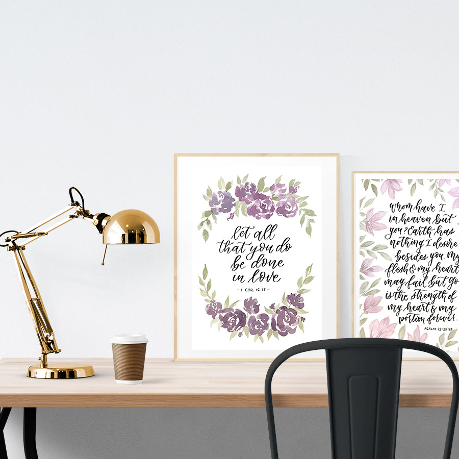 A3 beautiful calligraphy poster placed standing next to a smaller A4 sized calligraphy poster on a wooden table. Modern home interior design ideas.