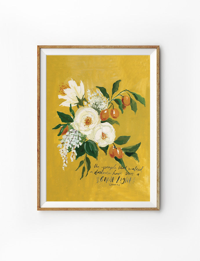 Poster featuring typography bible verses with flowers designs ‘The people who walked darkness have seen a great light.’ is hung on the wall in a gold photo frame. 200GSM paper, available in A3,A4 size.