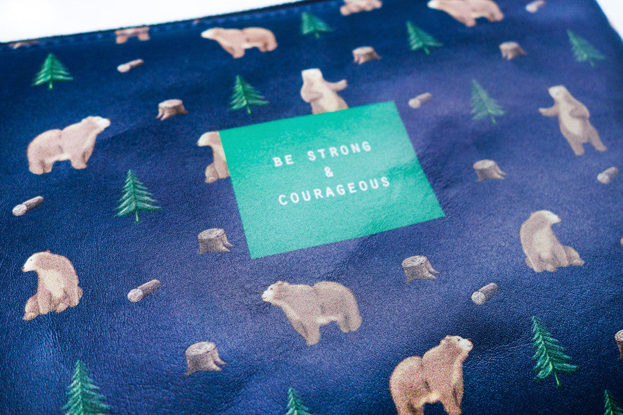 Close-up of Be Strong & Courageous Christian encouragement pouch design.