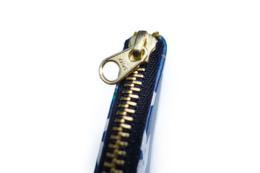 Be Strong & Courageous pouch with gold zip detail.