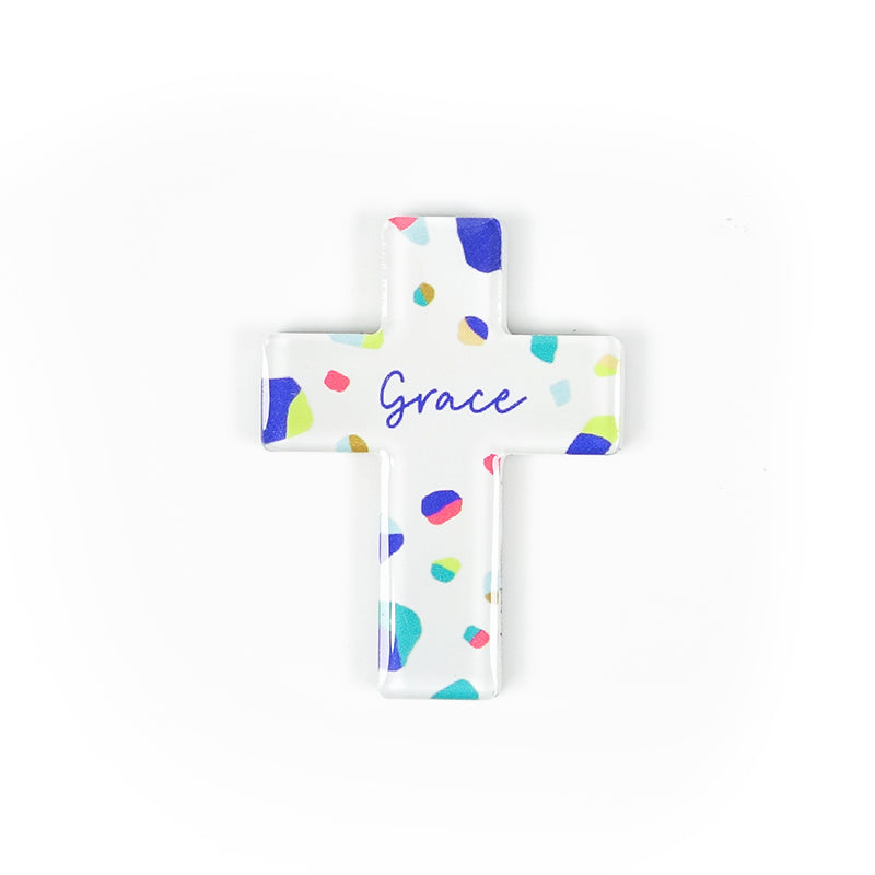Cross acrylic magnet with colourful terrazzo design. And the encouraging message 'Grace' in blue.