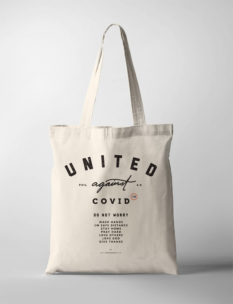 United against covid-19 and do not worry design printed on tote bag by The Commandment Co