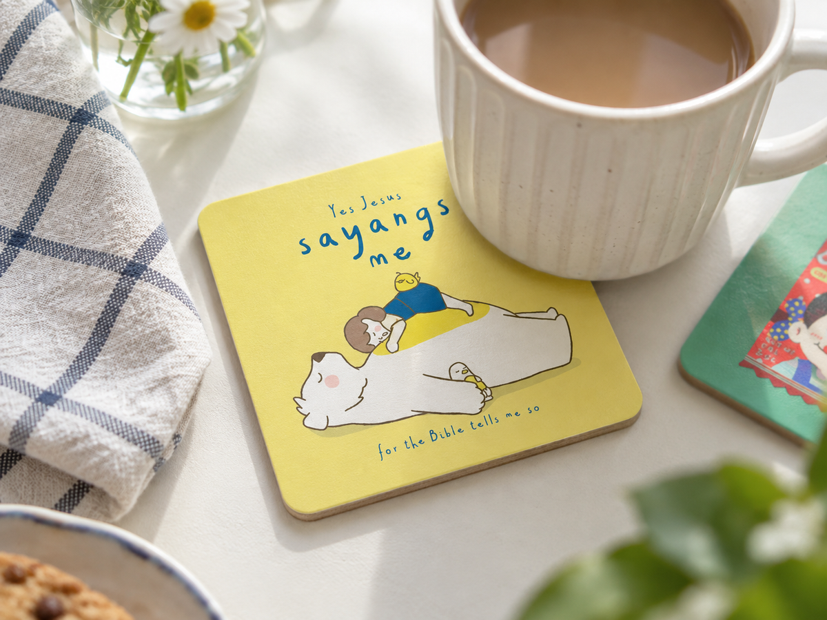 Yes Jesus Sayangs Me Christian wooden coaster with a coffee mug on a bright tabletop