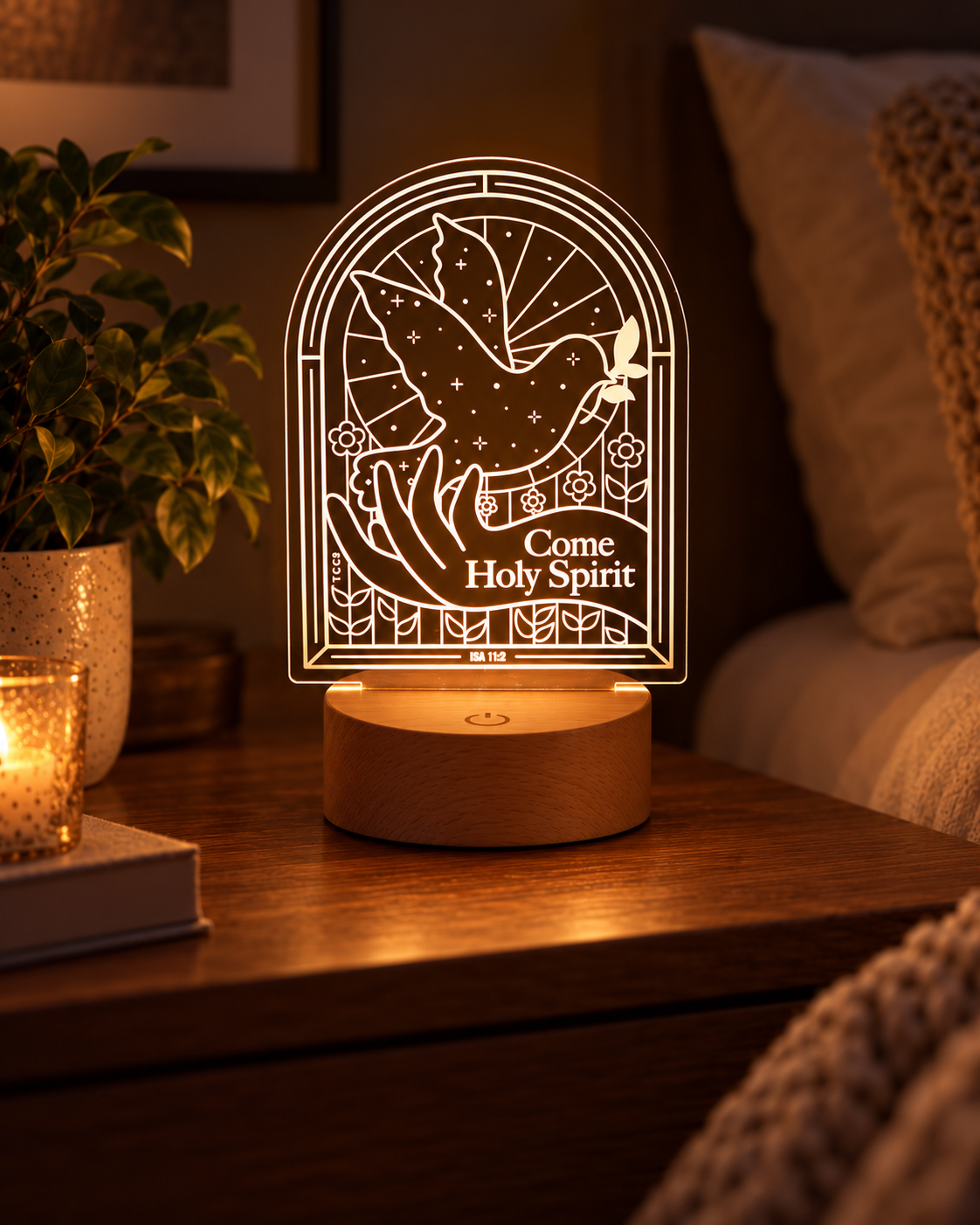 Come Holy Spirit Christian night light glowing on a warm bedside table