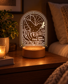 Come Holy Spirit Christian night light glowing on a warm bedside table