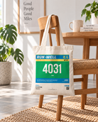 Run Well customisable marathon bib Christian tote bag hanging from a wooden chair in a bright Scandinavian interior