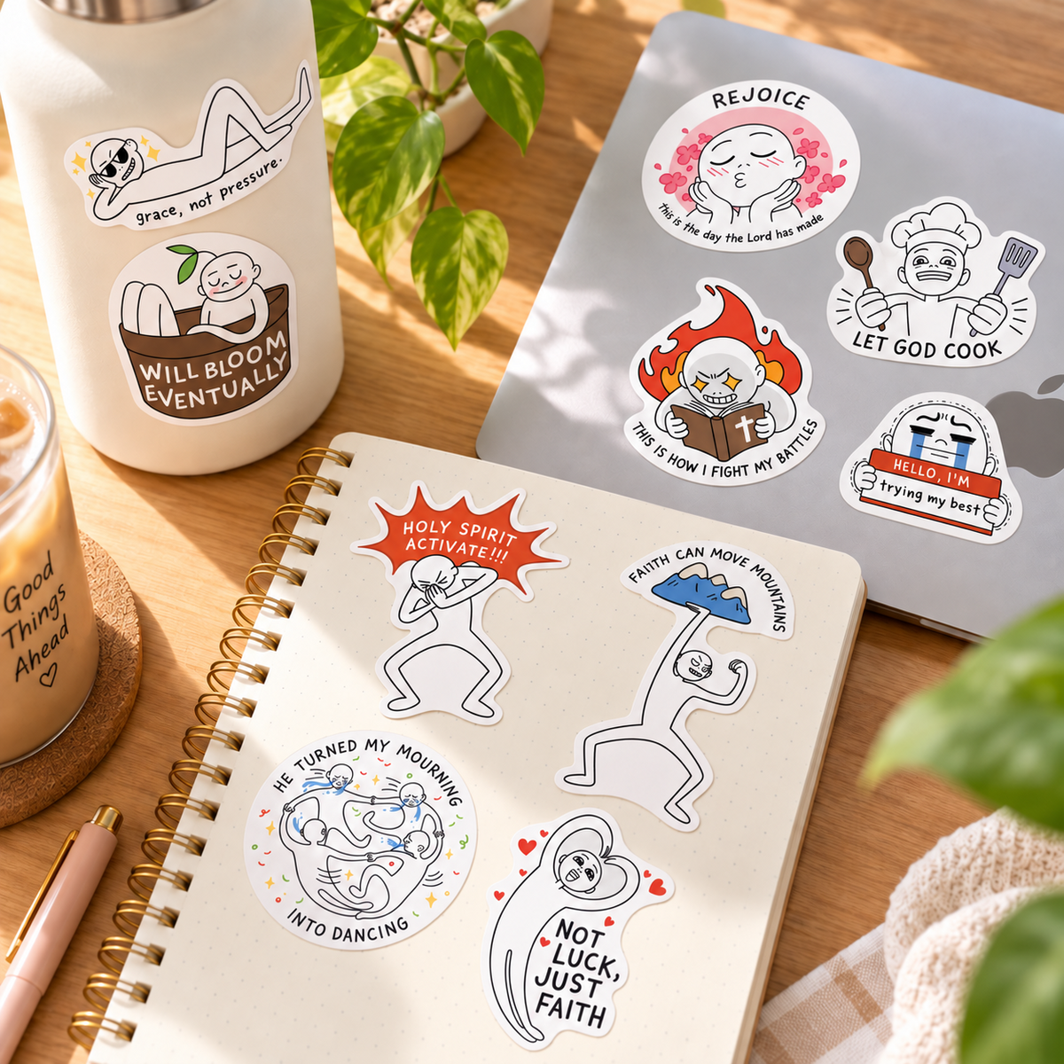 Vol. 1 Let God Cook Everyday Believer Christian stickers arranged on a notebook, laptop and bottle in a warm sunlit desk setting