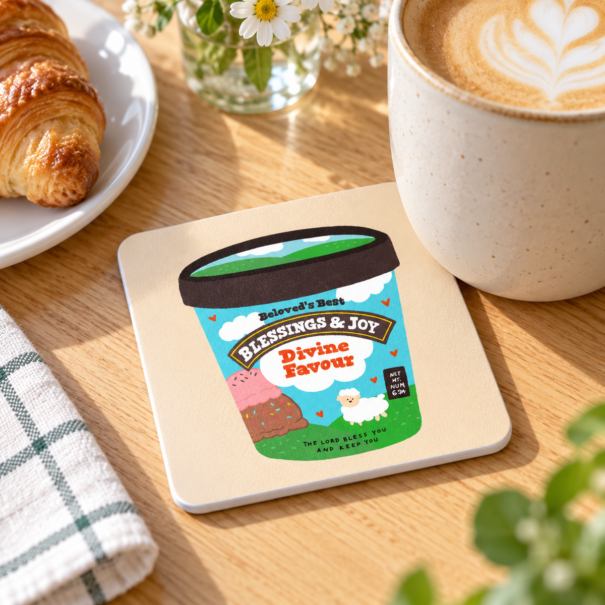 Divine Ice Cream Love Supermarket Christian coaster with white sides styled beneath a coffee mug in a bright breakfast setting
