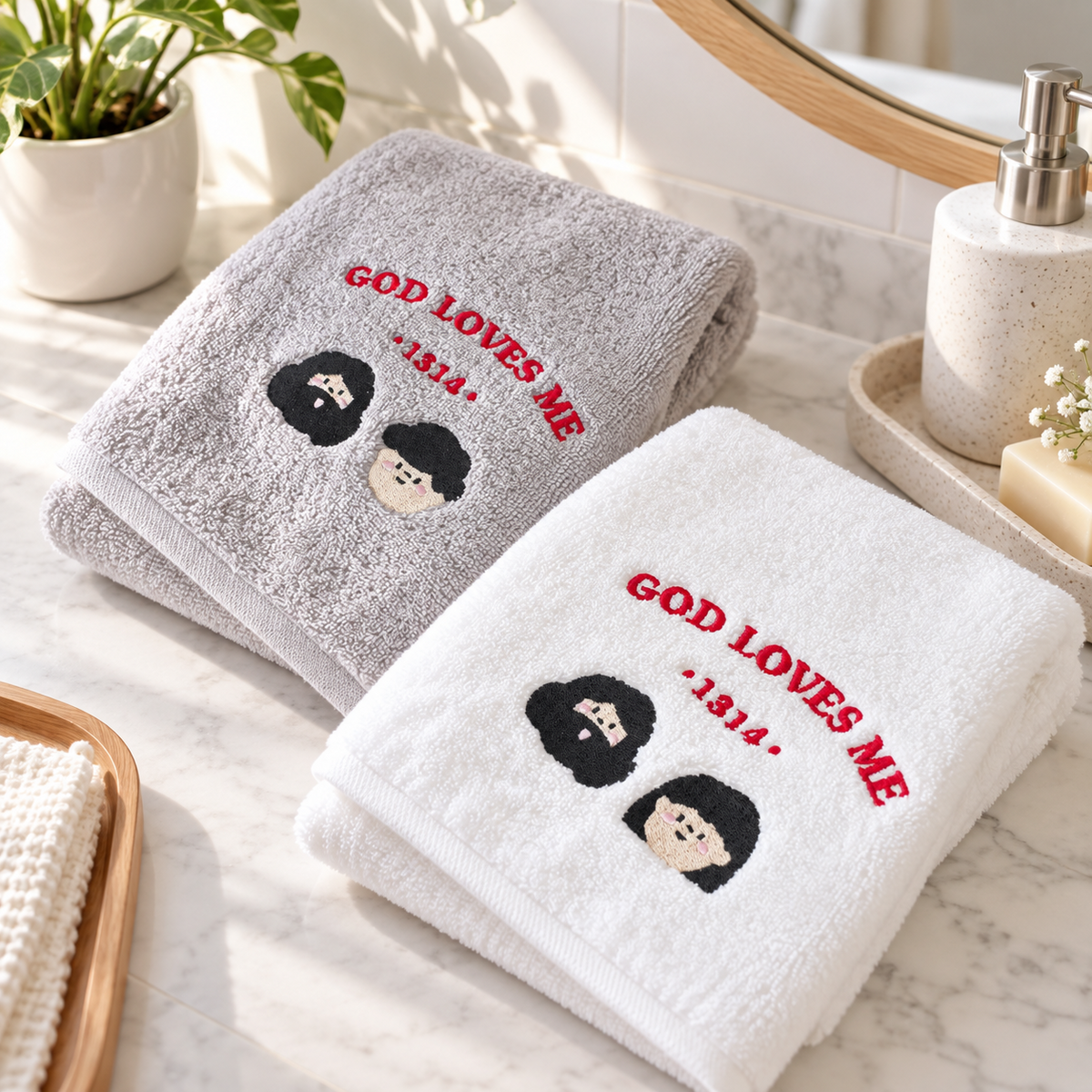 God Loves Me 1314 embroidered grey and white Christian towels styled in a bright bathroom setting
