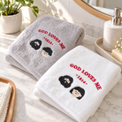 God Loves Me 1314 embroidered grey and white Christian towels styled in a bright bathroom setting