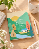 Mercy Peace and Love Jude 1:2 A5 Christian notebook styled on a warm wooden desk with coffee and stationery