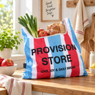 Provision Store reusable Christian shopping bag filled with groceries in a bright warm kitchen setting
