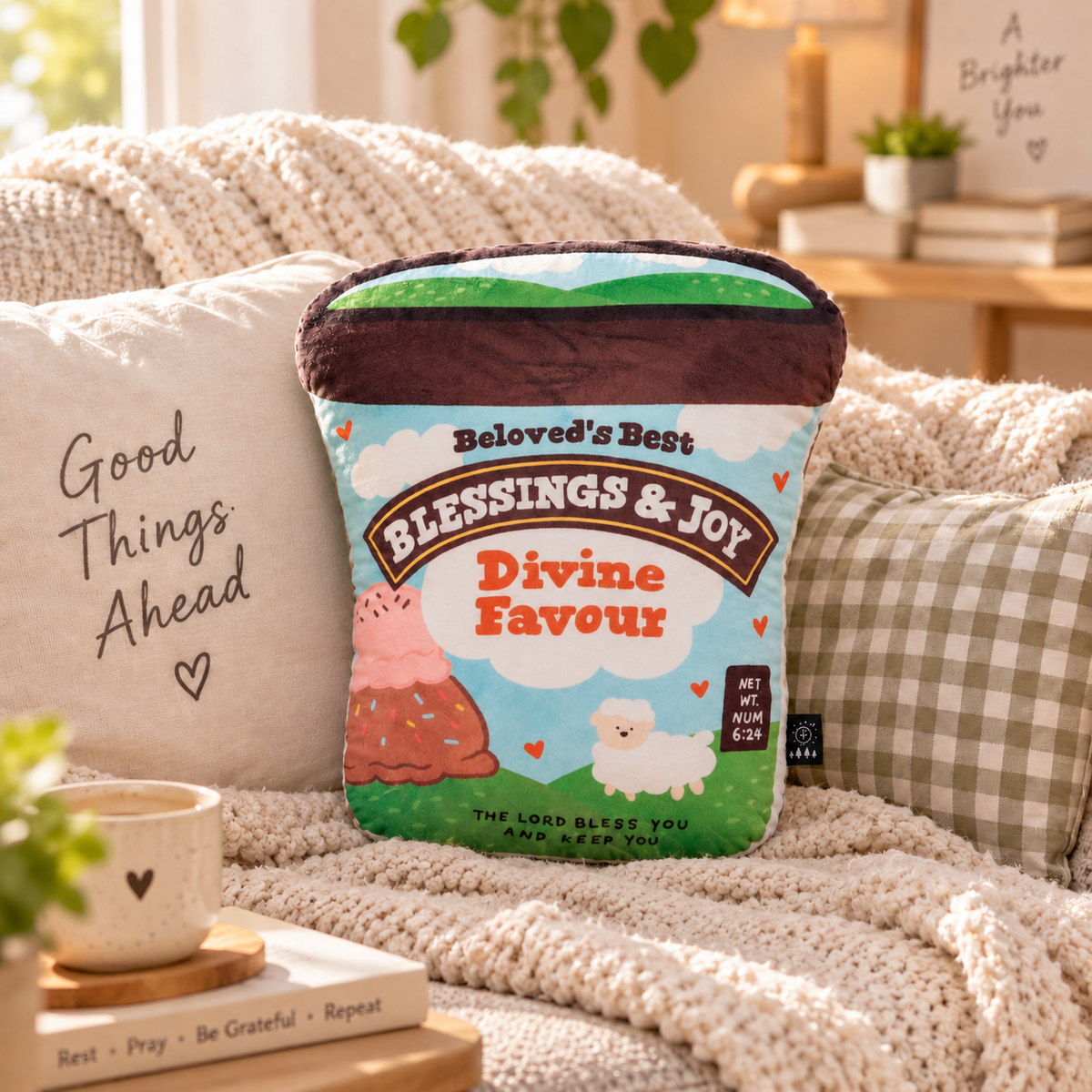 Divine Ice Cream Christian plush toy styled smaller among cosy neutral cushions in a warm sunlit living room
