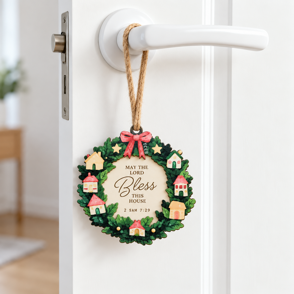 Bless This Home Christian Christmas tree bauble hanging from a white door handle, inspired by 2 Samuel 7:29