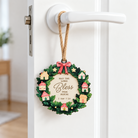 Bless This Home Christian Christmas tree bauble hanging from a white door handle, inspired by 2 Samuel 7:29