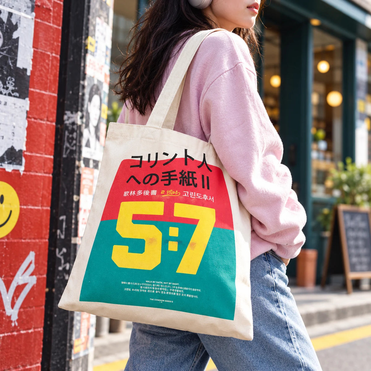 Walk by Faith Not by Sight 2 Corinthians 5:7 tote bag with colourful multilingual typography worn on a city street