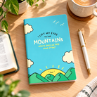 My Help Comes From The Lord A5 Christian notebook on a sunlit wooden desk with coffee and greenery